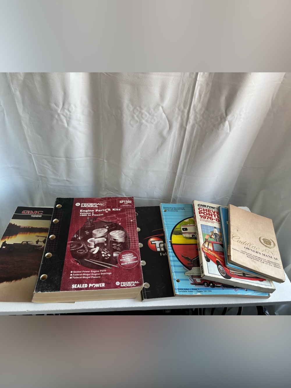 Collection of vintage vehicle catalogs and vehicle manuals